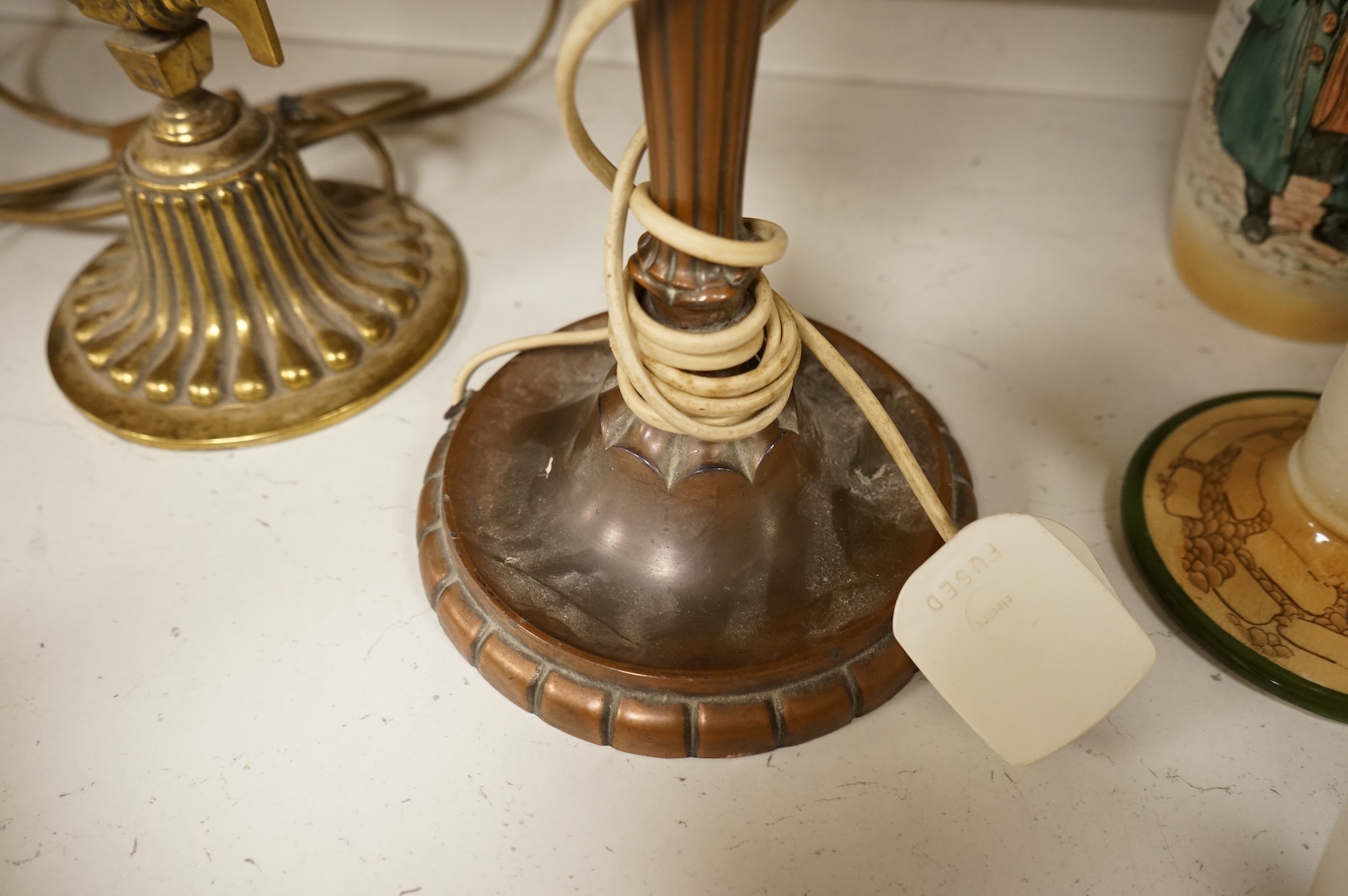 A copper table lamp and a brass students lamp